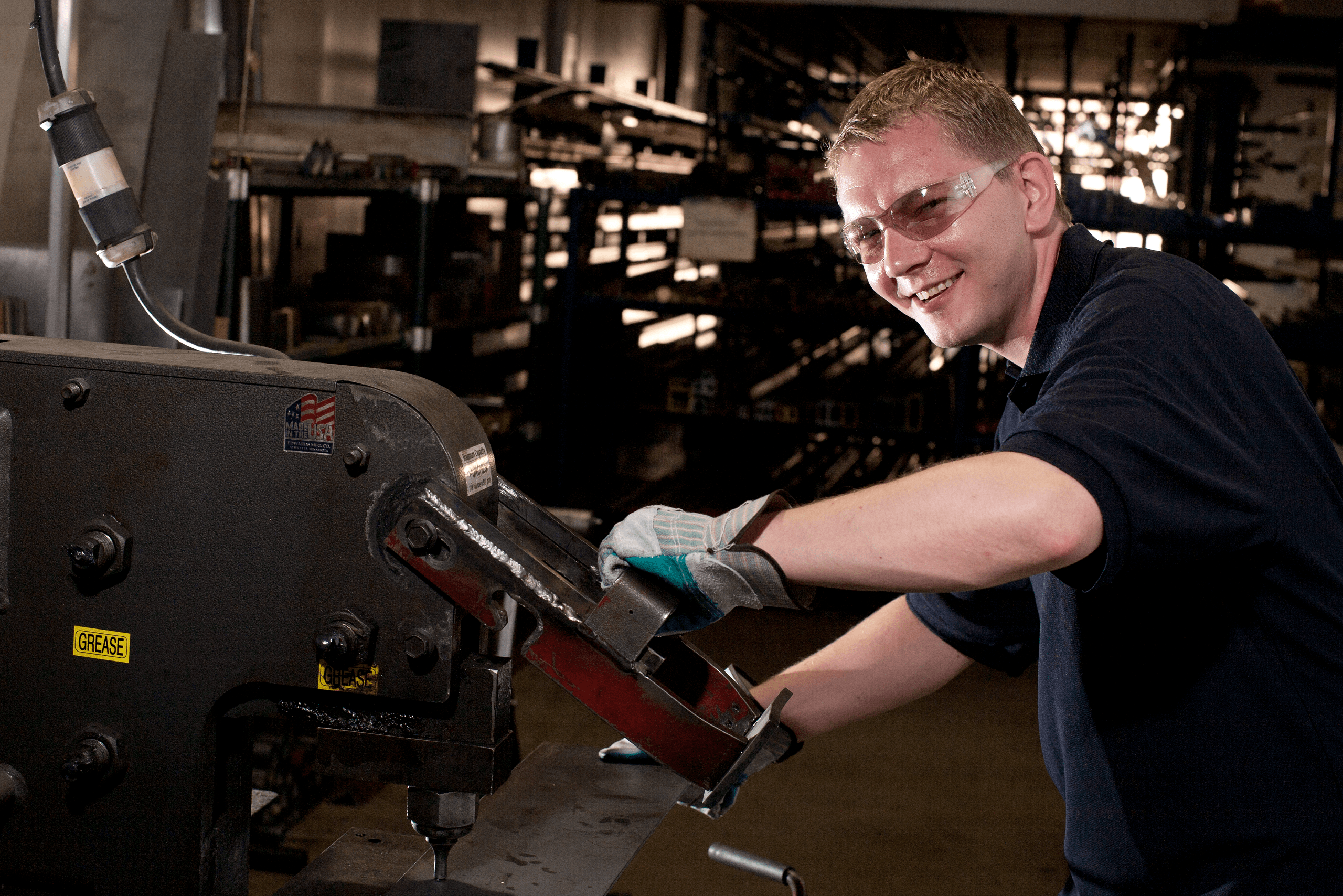 smiling man using ironworker machine